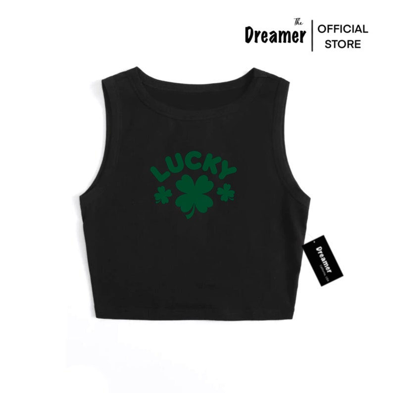 May include: Black sleeveless crop top with the word "LUCKY" in green letters and a green four-leaf clover graphic.