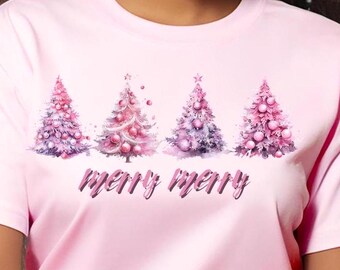 May include: Pink t-shirt with a watercolor design of four Christmas trees with pink and purple ornaments and the text "merry merry" printed on the front.