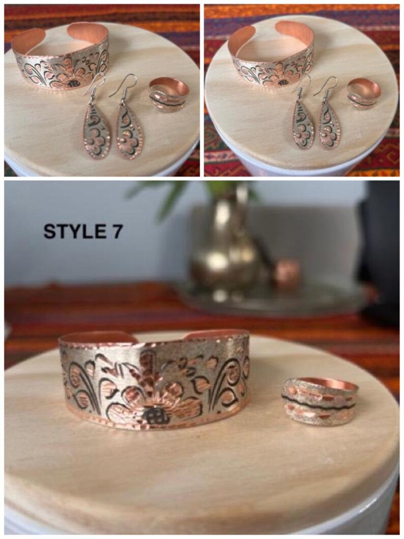 May include: A set of copper jewelry with a floral design. The set includes a bracelet, a pair of earrings, and a ring. The jewelry is made of copper and has a silver finish. The jewelry is on a wooden surface. STYLE 7
