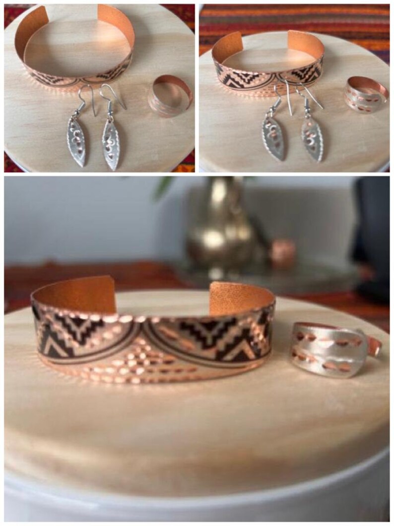 May include: A set of copper jewelry featuring a bracelet, a ring, and a pair of earrings. The bracelet and ring have a hammered texture and a geometric pattern. The earrings are silver with a leaf design.