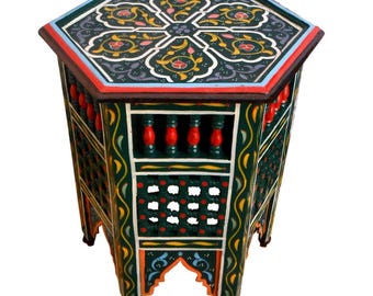 May include: Octagonal wooden table with intricate hand-painted floral designs in green, yellow, red, blue, and white. The table has a latticework design on the sides and legs.
