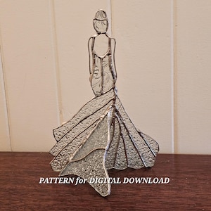 May include: A clear glass sculpture of a woman in a long gown, with a detailed back and flowing skirt. The sculpture is on a wooden surface, with the text "PATTERN for DIGITAL DOWNLOAD" at the bottom.