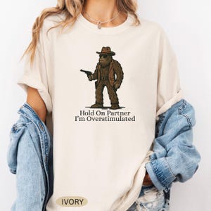 Funny Bigfoot T-Shirt, Hold On I&#39;m Overstimulated Shirt, Western Sasquatch Shirt, Cryptid Lover T-Shirt, Cryptozoology Shirt, Big Foot Gift