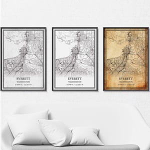 May include: Three framed prints of Everett, Washington, maps in monochrome and sepia. Each print shows a detailed street map with the city name and coordinates. The frames are black.