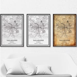 May include: Three framed maps of Tallahassee, Florida, in black frames. The maps have a detailed street layout. One map is black and white, one is sepia-toned, and the other is black and white.