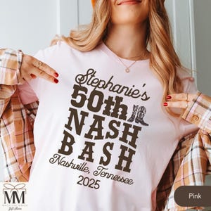 May include: Pink t-shirt with brown text that reads "Stephanie's 50th NASH BASH Nashville, Tennessee 2025".