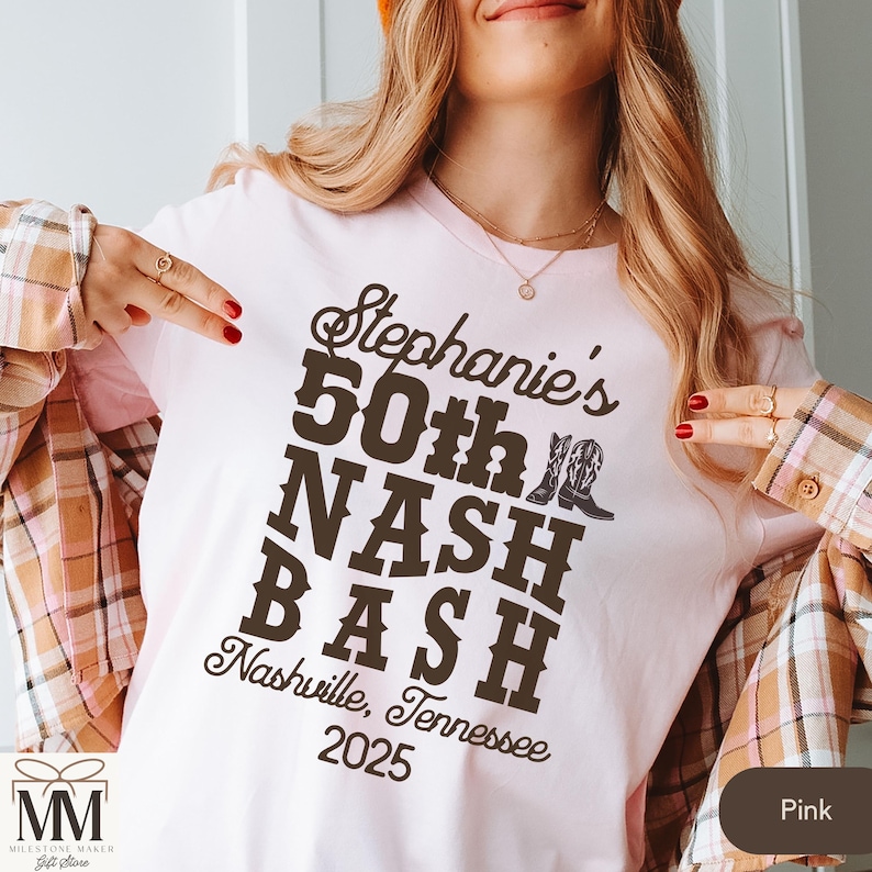 May include: Pink t-shirt with brown text that reads "Stephanie's 50th NASH BASH Nashville, Tennessee 2025".