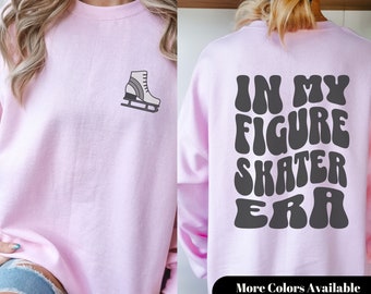 May include: Pink sweatshirt with a gray figure skate graphic on the front and the text "IN MY FIGURE SKATER ERA" in a retro font on the back.