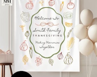 May include: White Thanksgiving banner with a green border and the text "Welcome to Smith Family Thanksgiving Making Memories Together." The banner is decorated with colorful illustrations of vegetables and fruits.
