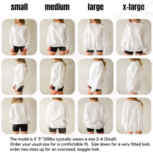 May include: A white crewneck sweatshirt in four different sizes: small, medium, large, and x-large. The model is 5'5" and 120 lbs and typically wears a size 2-4 (Small). Order your usual size for a comfortable fit. Size down for a very fitted look, order two sizes up for an oversized, baggie look.