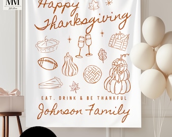 May include: A white Thanksgiving-themed banner with brown text and illustrations. The banner reads "Happy Thanksgiving," "Eat, Drink & Be Thankful," and "Johnson Family." Illustrations include a pie, football, pumpkins, and champagne glasses.