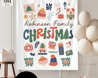 May include: A white Christmas tapestry with colorful illustrations and the text "Robinson Family CHRISTMAS." The design includes a Christmas tree, ornaments, a house, and a winter hat. A black circle at the bottom says "CUSTOM."