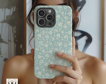 May include: A light blue phone case with a white floral pattern. The case has a camera lens cutout and a raised lip around the edges.