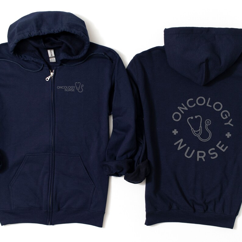 May include: Navy blue zip-up hoodie with a small gray graphic of a stethoscope and the text "Oncology Nurse" on the left chest. The back of the hoodie has a larger gray graphic of a stethoscope in a circle with the text "Oncology Nurse".