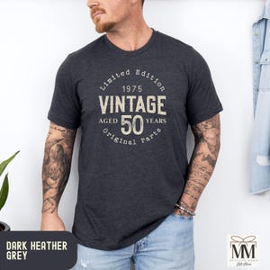 Peut inclure: T-shirt gris chin&eacute; fonc&eacute; avec un design vintage pour un 50e anniversaire. Le t-shirt comporte le texte "&Eacute;dition limit&eacute;e 1975 Vintage &Acirc;g&eacute; de 50 ans Pi&egrave;ces d'origine".