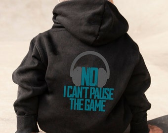 May include: Black hooded sweatshirt with a blue graphic that says "NO I CAN'T PAUSE THE GAME" with a headphone icon.