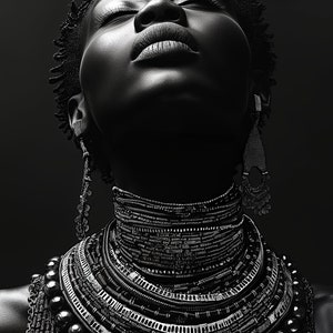 May include: A black and white portrait of a person wearing a layered necklace of beads and other jewelry. The person is looking up with their eyes closed.