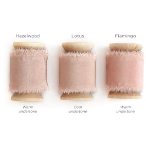 May include: Three spools of pink ribbon, labeled "Hazelwood", "Lotus", and "Flamingo". Each spool has a wooden base and a warm or cool undertone.