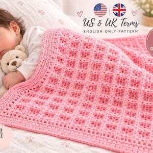May include: A pink crocheted baby blanket with a waffle stitch texture. The digital download pattern includes US and UK terms. The text on the image reads US & UK Terms, English Only Pattern, Digital Download, and Make Something Beautiful.