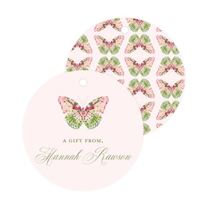 May include: Round pink gift tags with a green and pink butterfly design. The tag says "A gift from, Hannah Rawson".