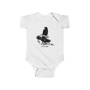 May include: White baby onesie with a black and white graphic of two crows with a banner that reads "We Keep Us Safe <1312".