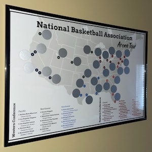 May include: A map of the United States with circles representing the locations of National Basketball Association (NBA) teams. The map is framed in black and has the text "National Basketball Association Arena Tour" at the top.