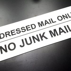 May include: White sign with black text that reads "Addressed Mail Only" and "No Junk Mail".