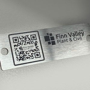 May include: A silver metal tag with a black QR code and the text "Finn Valley Plant & Civil pty ltd" printed on it.