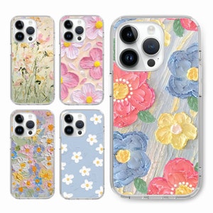 May include: Four phone cases with different floral designs. The cases are clear and show the phone's design through the case. The designs include a blue and pink floral design, a yellow and pink floral design, a blue and white floral design, and a green and yellow floral design.