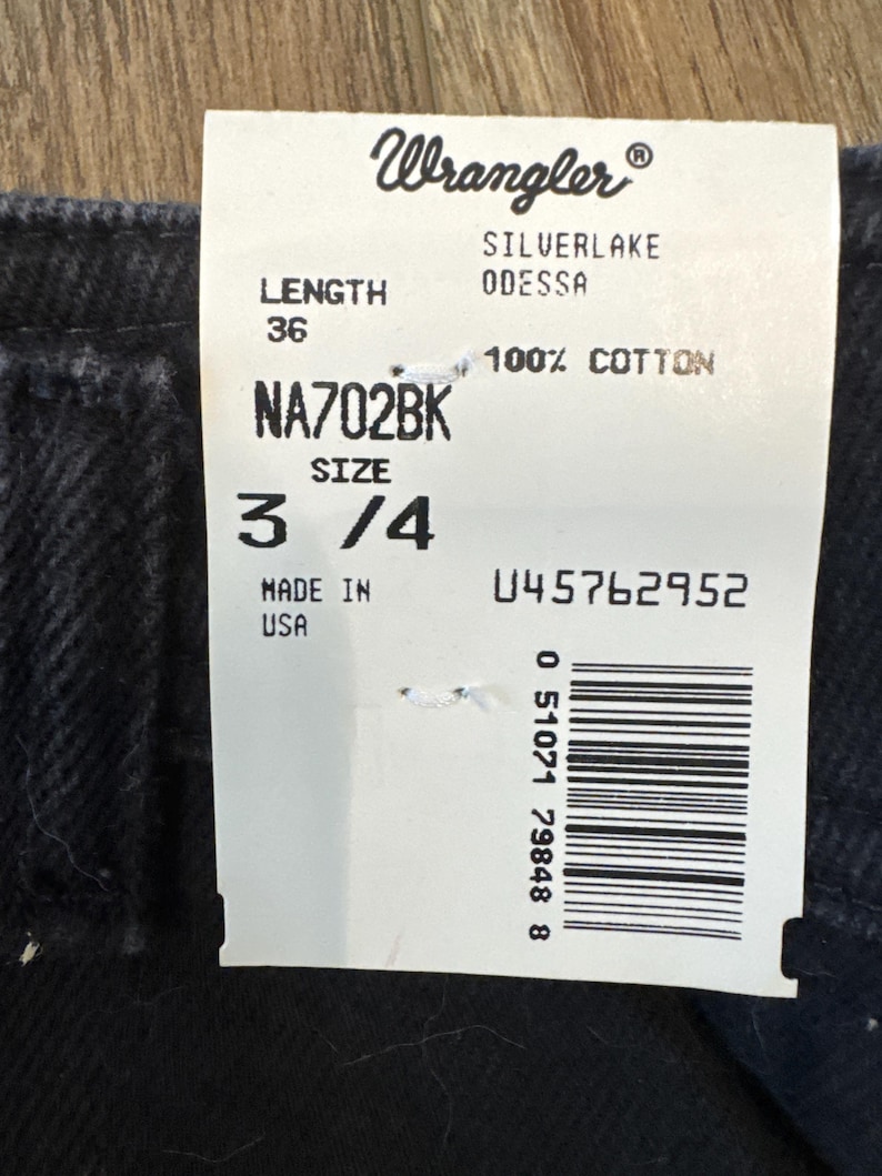May include: A Wrangler jeans tag with the brand logo and product information. The tag displays "SILVERLAKE ODESSA" jeans, size 3/4, and a length of 36 inches (91.4 cm). The material is 100% cotton. The tag also includes the text "MADE IN USA".