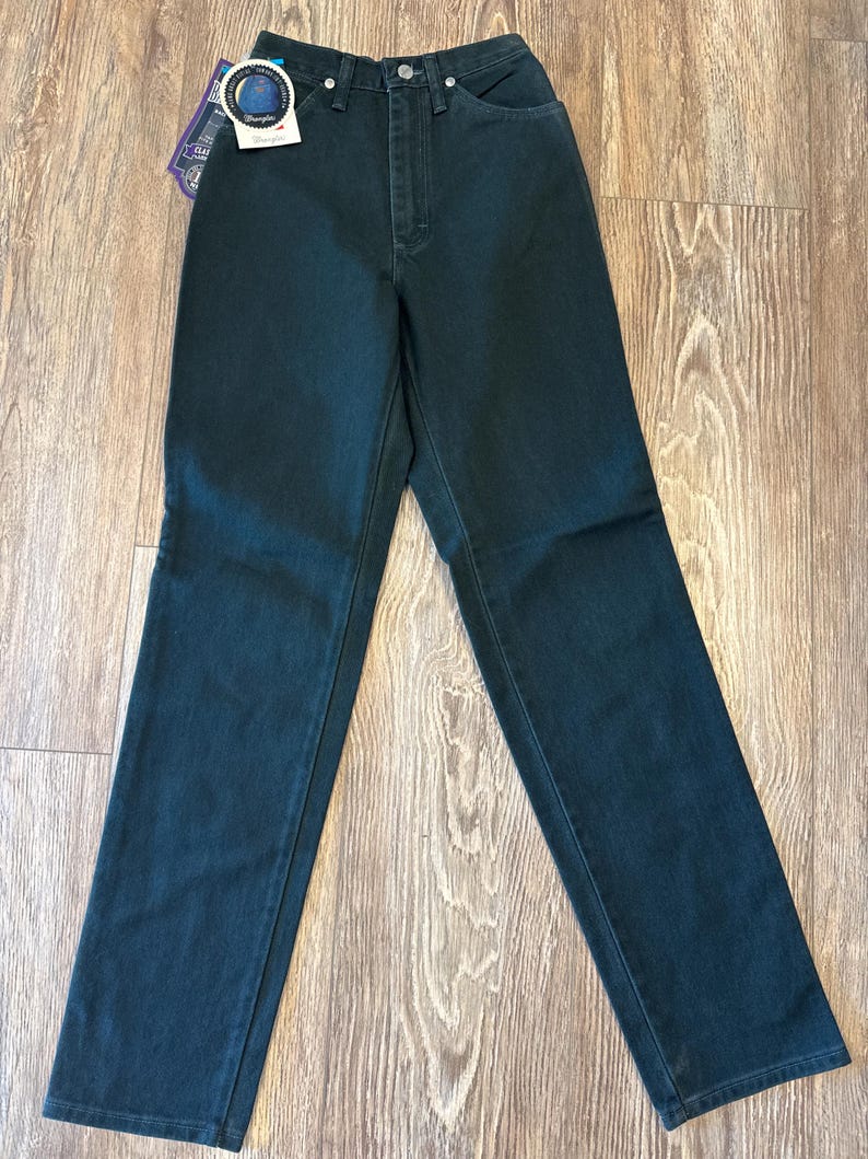 May include: Dark green high-waisted jeans with a button and zipper closure. The jeans have a straight leg fit and are made of a soft, comfortable fabric.