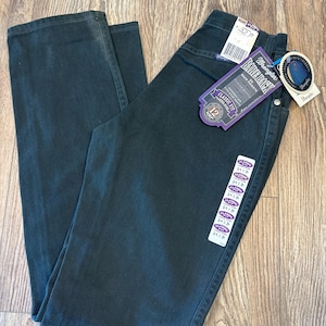 May include: A pair of dark green Wrangler jeans with a purple tag that says "Bareback" and "Classic Fit".