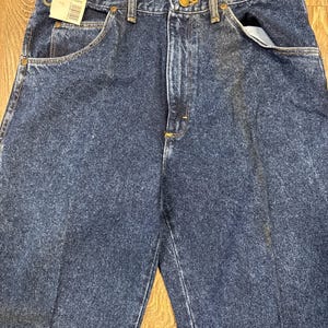 Puede incluir: Vaqueros de mezclilla azul oscuro con un dise&ntilde;o cl&aacute;sico de cinco bolsillos. Los vaqueros tienen cierre de bot&oacute;n y cremallera, y la etiqueta indica una cintura de 86 cm y una entrepierna de 86 cm. Los vaqueros est&aacute;n hechos de un material de mezclilla duradero.
