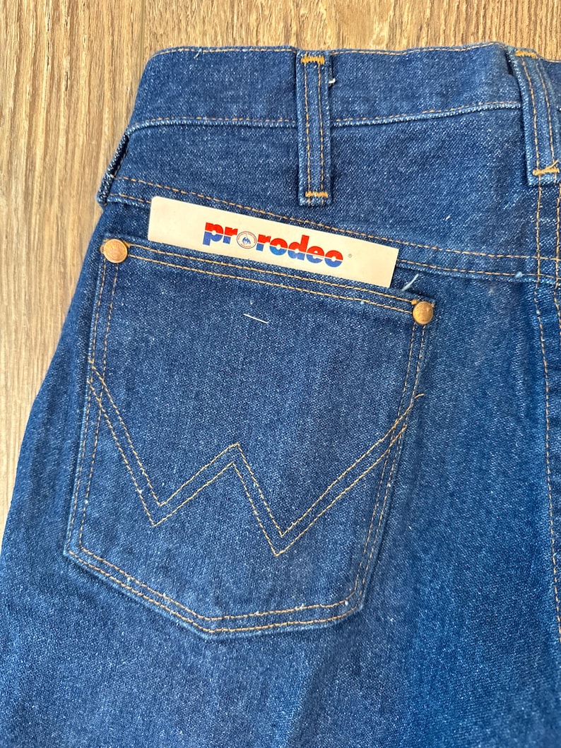 May include: A pair of blue denim jeans with a back pocket featuring a stitched