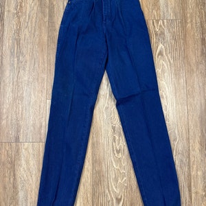 May include: A pair of dark blue denim jeans with a high waist and a straight leg.