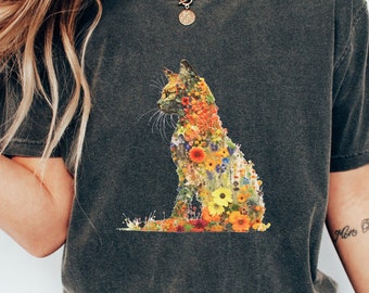 May include: A dark gray t-shirt with a floral cat design. The cat is made up of colorful flowers and is sitting in a relaxed pose.