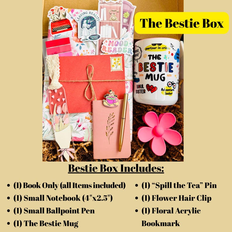 May include: A gift box labeled "The Bestie Box" filled with various items. Includes a mug with "The Bestie Mug" text, a pink flower hair clip, a notebook, a pen, a pin, and a floral bookmark. The box is filled with decorative paper.