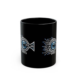 May include: A black ceramic mug featuring a graphic design with a blue and silver camera lens icon surrounded by circuit board patterns. The text AI FILM PRO is printed in white and blue lettering on the side of the mug, centered within the design.