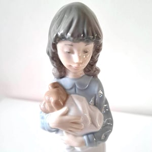 NAO by Lladro Young Girl hugs a puppy