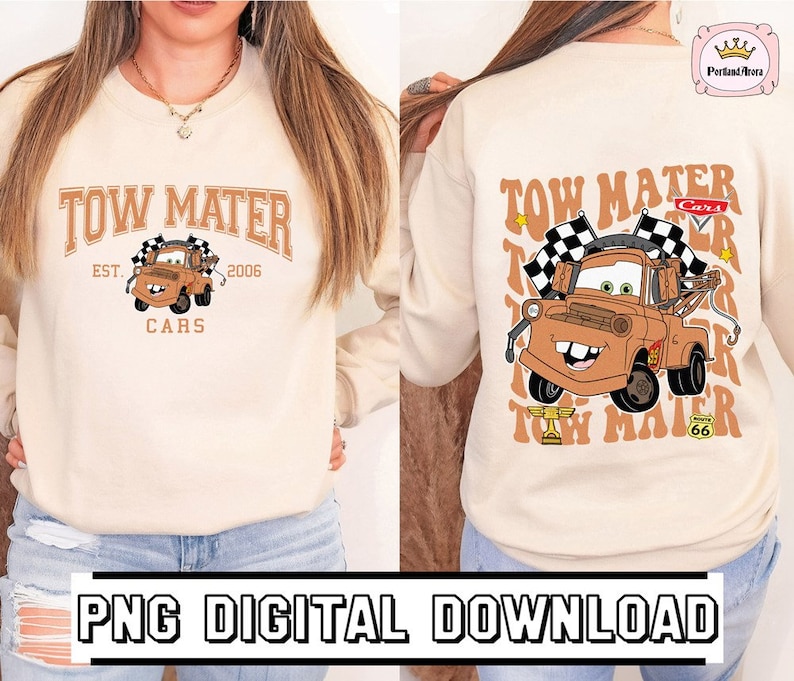May include: A beige sweatshirt with a graphic print of Tow Mater from the Cars movie. The graphic includes the text "Tow Mater" in a retro font, the text "Cars" in a smaller font, and the text "Est. 2006" in a smaller font. The graphic also includes a checkered flag and the number 66.