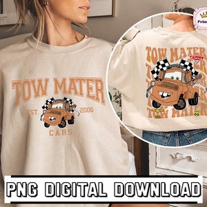 May include: A beige sweatshirt with a graphic of Tow Mater from the movie Cars. The graphic includes the text "Tow Mater", "Est. 2006", and "Cars".
