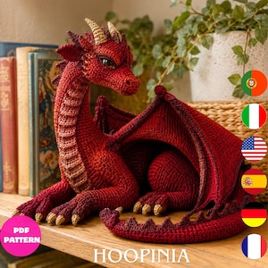 May include: A handcrafted red crochet dragon figurine featuring textured scales, tan-colored horns, and claws. The dragon is depicted in a resting position with its wings partially spread, showcasing intricate yarn work and detailed facial features.