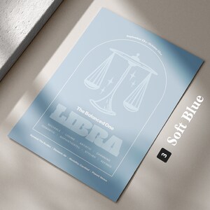 Może przedstawiać: Jasnoniebieski plakat z białym obrysem wagi i słowem "LIBRA" w pogrubionych białych literach. Tekst "The Balanced One" znajduje się nad wagą, a daty "September 23rd - October 22nd" znajdują się nad tekstem. Tekst "Soft Blue" znajduje się w prawym dolnym rogu plakatu z numerem "3" w czarnym k&oacute;łku.