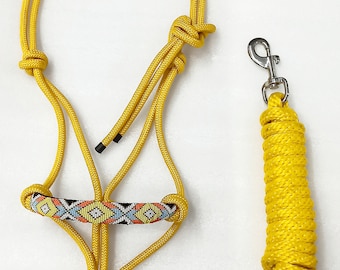 May include: A yellow rope halter with a colourful beaded noseband and a matching lead rope with a silver clip.