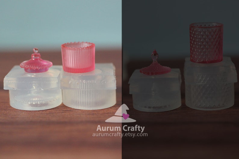 May include: Two sets of clear glass candle holders with pink lids. The candle holders have a textured design. The lids have a small knob on top.