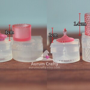 May include: Three clear silicone moulds for making miniature glass jars with lids. The moulds are 1 cm in diameter and 1.4 cm tall. The jars are pink and have a diamond pattern.