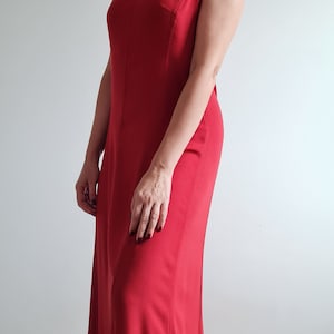 anastasia steele red dress Steal the look! Anastasia Steeles dreamy pink chiffon dress from Fifty Shades of Grey is now yours to own. Perfect for summer, this halter neck beauty is the color of the season. Shop now and live