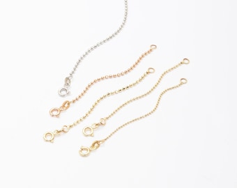 May include: Four gold chain extension pieces in different lengths, with a close-up of a gold chain with a blue birthstone charm attached. "Birthstone or Letter Charms" is written in the image.