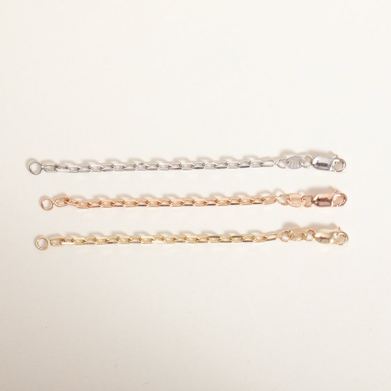 May include: Three chain necklaces in different colors: silver, rose gold, and gold. Each necklace has a lobster clasp closure.