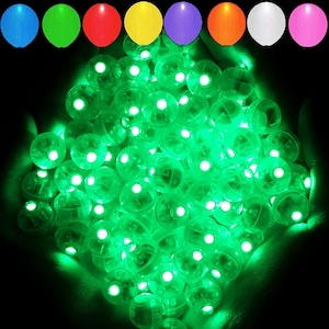 May include: A large pile of green LED light-up balloons. The balloons are round and have a clear plastic exterior with a small LED light inside.